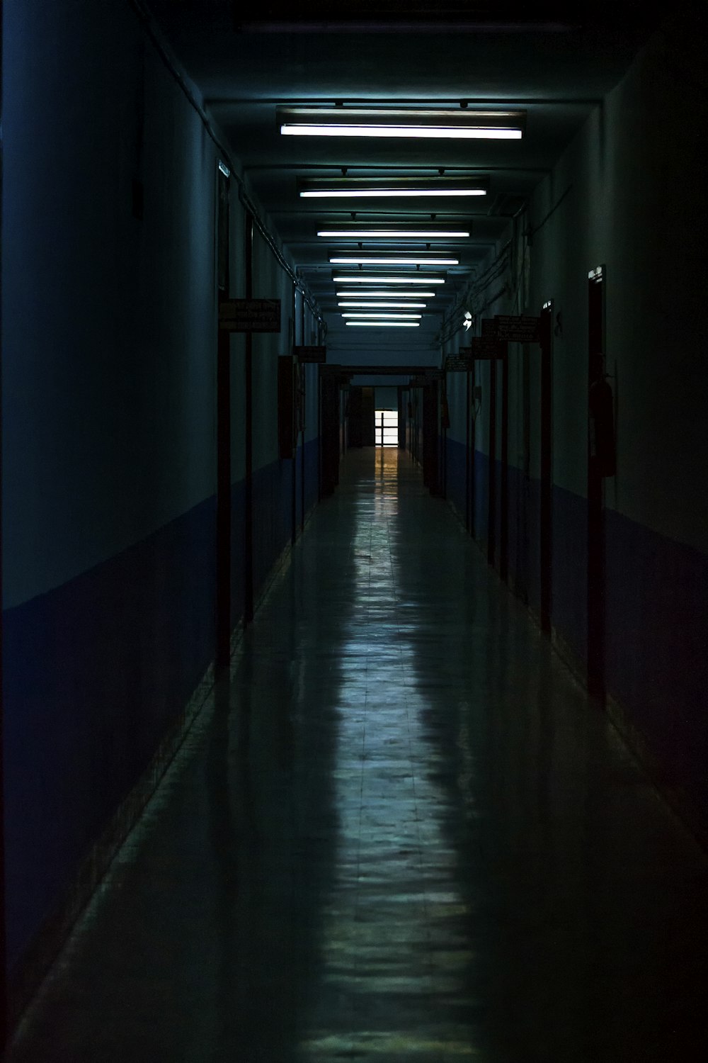 empty hallway with light turned on in the middle