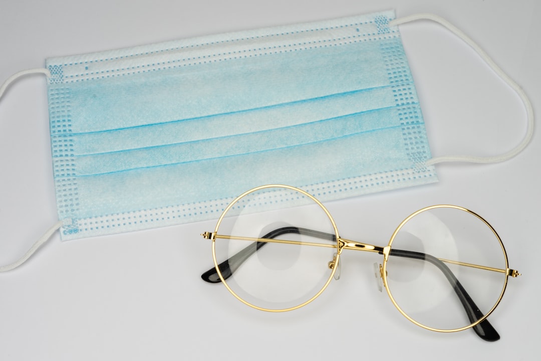 brown framed eyeglasses on blue and white textile
