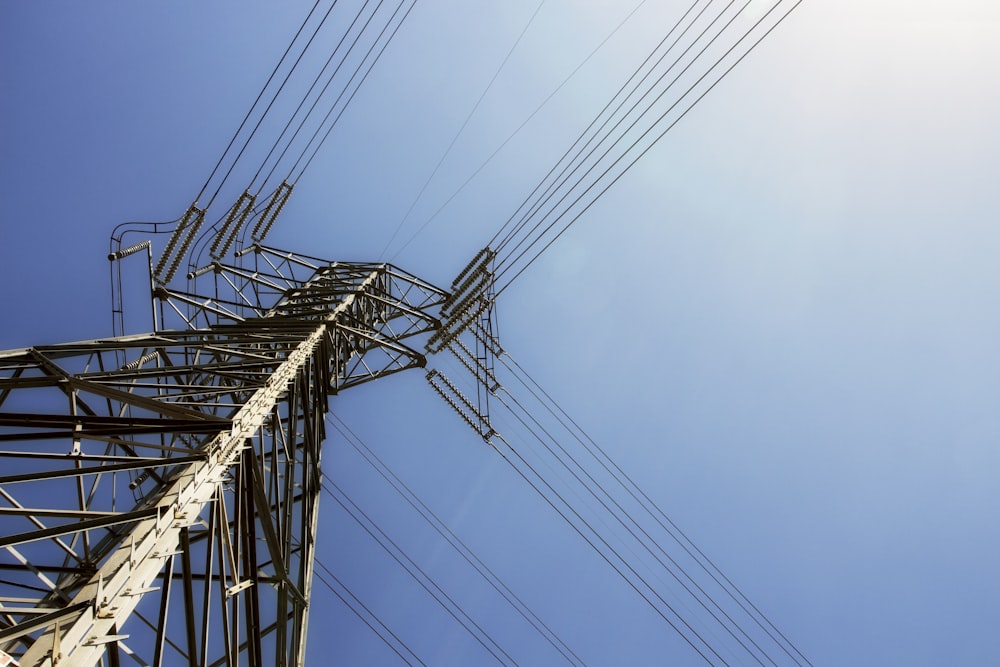 black electric post under blue sky during daytime