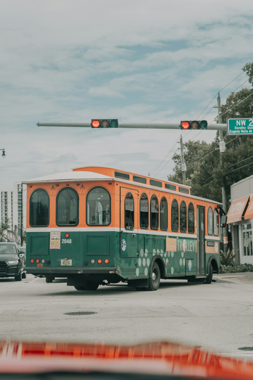 green and brown bus on road during daytime