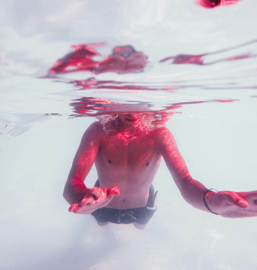 person in red shorts on water