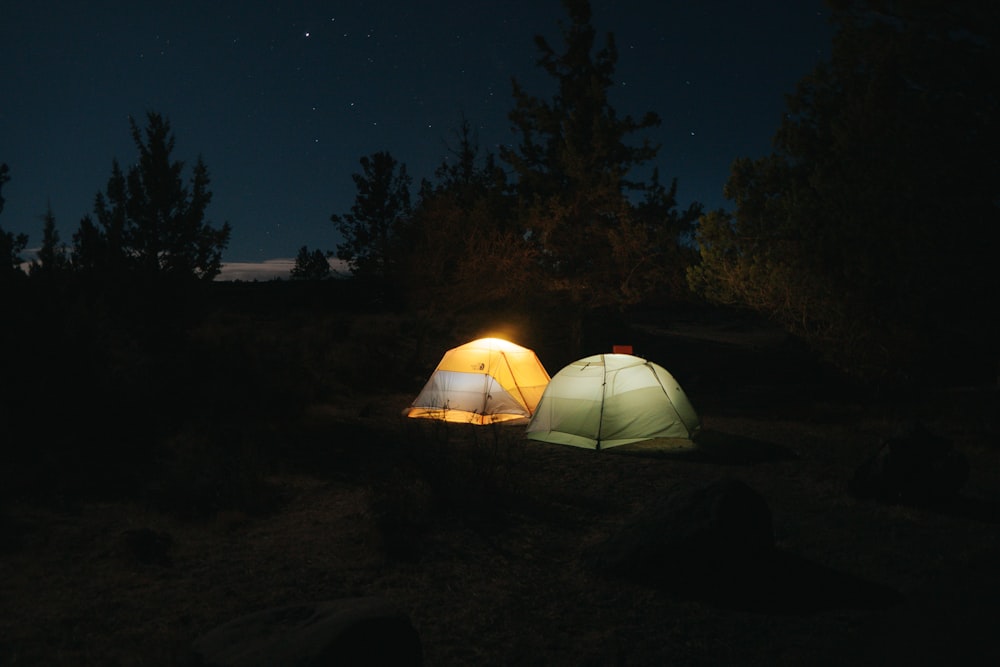 white tent on brown field during night time