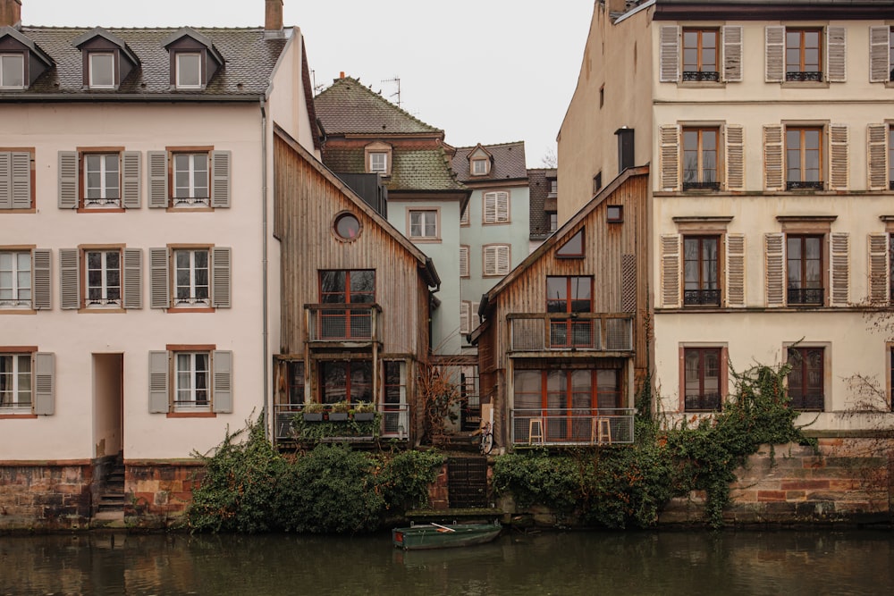 brown and white concrete building beside river during daytime