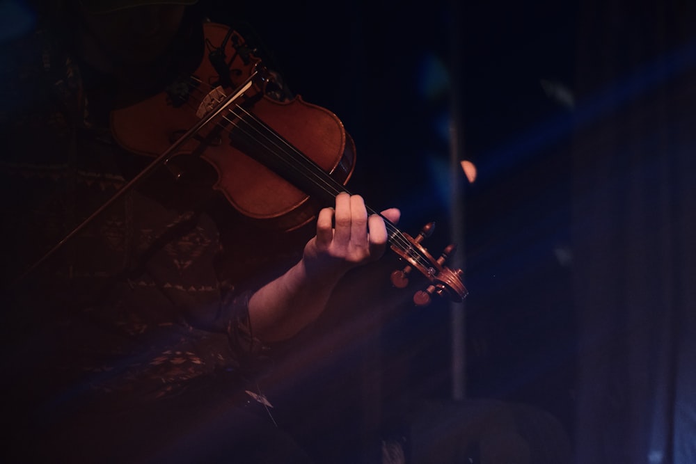 person playing violin during nighttime