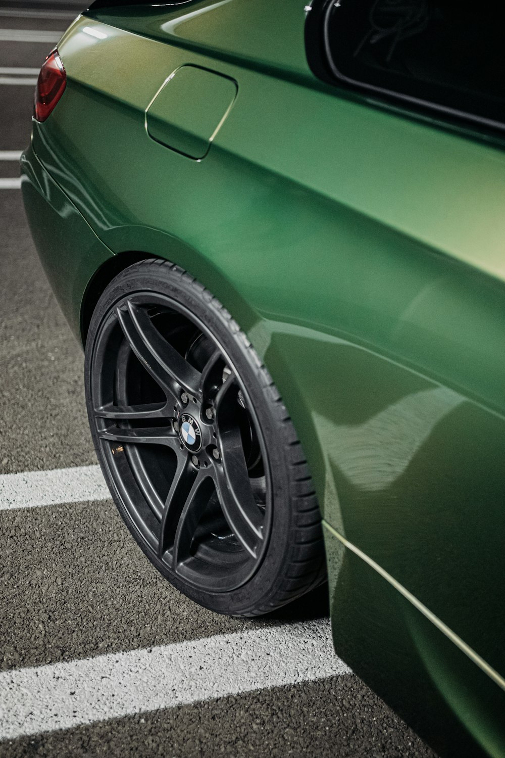 green car on gray asphalt road