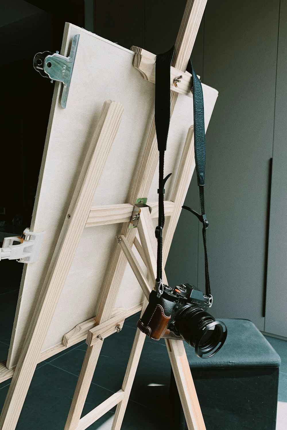 black dslr camera on white wooden cabinet