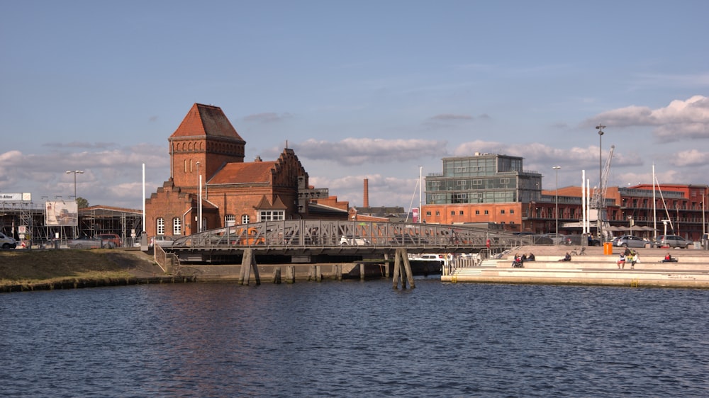 brown and white concrete building beside body of water during daytime