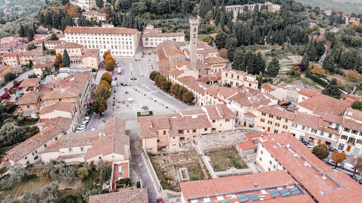 Fiesole — aerial view of the hilltop village above Florence with terracotta rooftops and Tuscan hills beyond