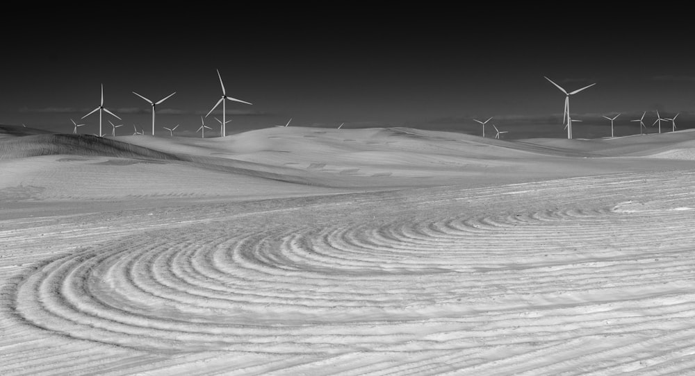 wind turbines on white sand during daytime