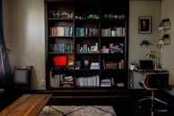 A cozy home office setup with books and a computer.