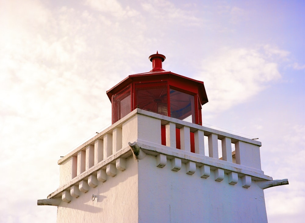 white concrete building with red roof under white sky during daytime