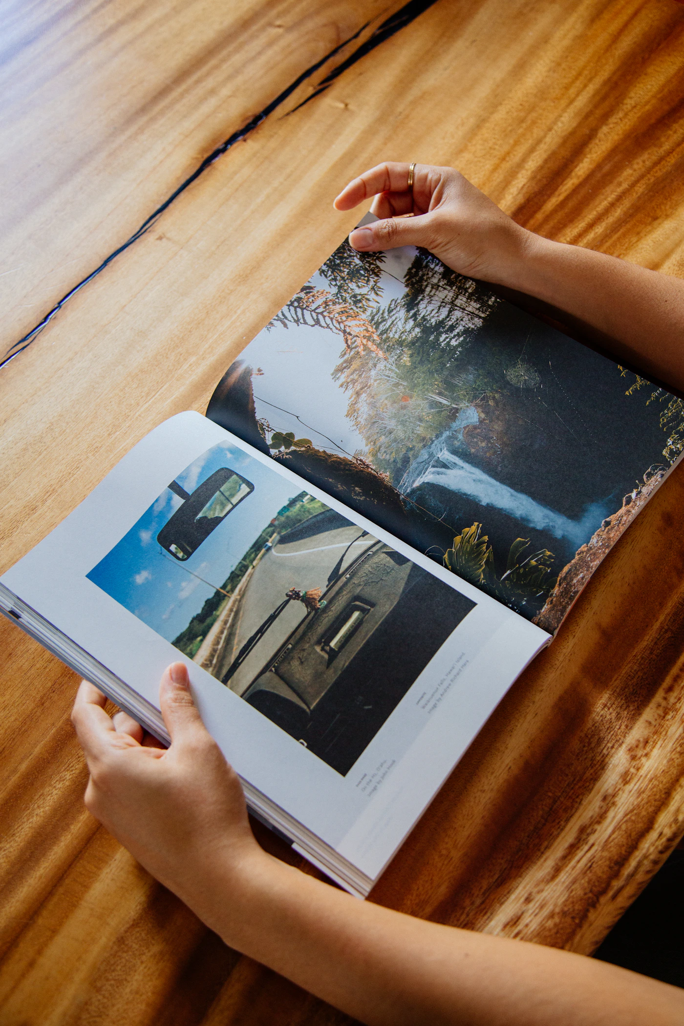 Close-up of a glossy magazine being read on a wooden tabletop