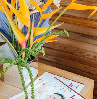 yellow and green plant on brown wooden table