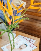 yellow and green plant on brown wooden table