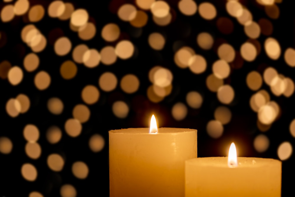 lighted candle on white and black polka dot textile