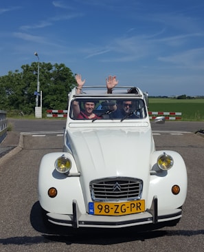 Happy customer receiving keys to their new Dutch-imported vehicle.