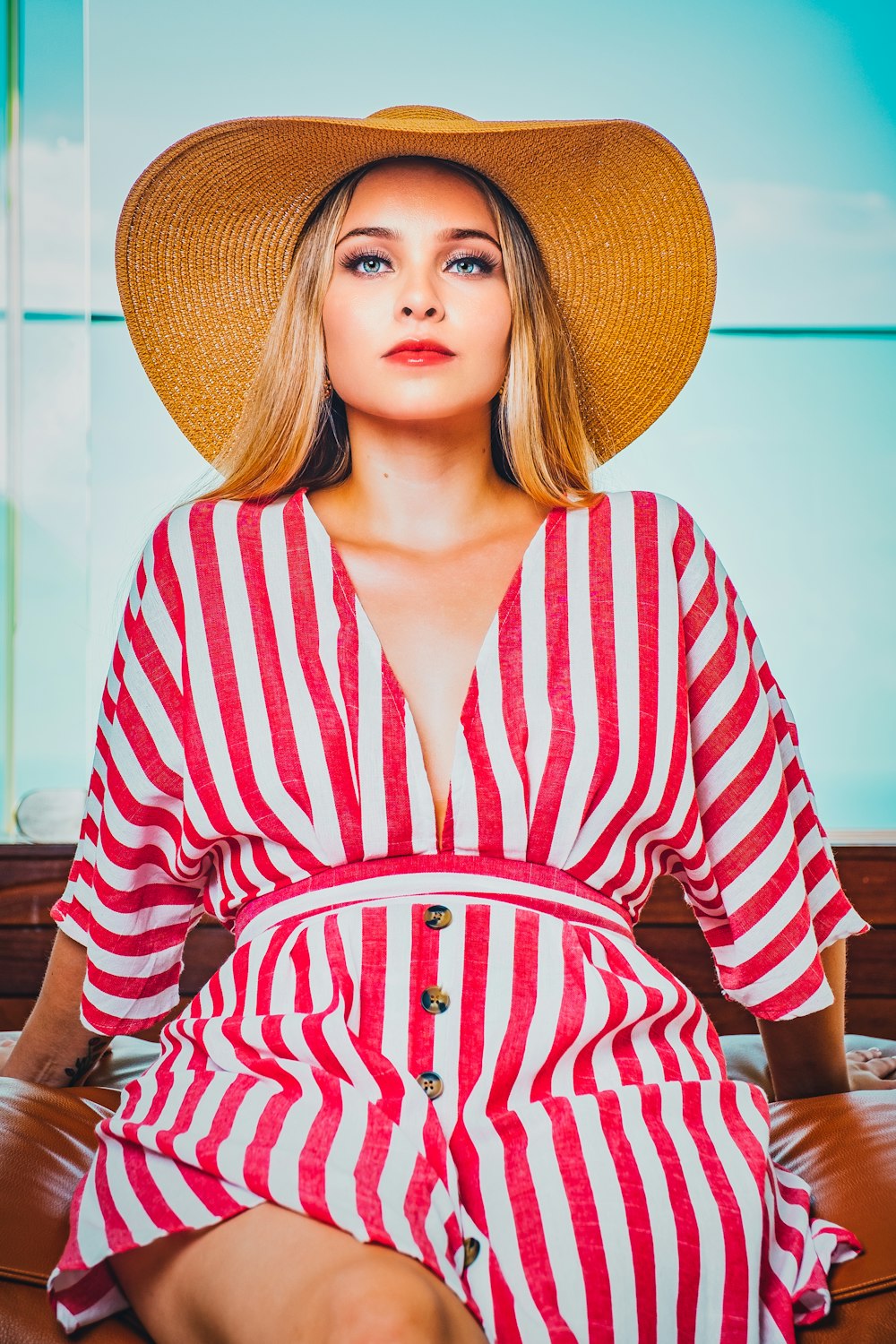 woman in red and white striped long sleeve shirt wearing brown hat