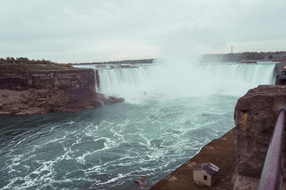 water falls under white sky during daytime