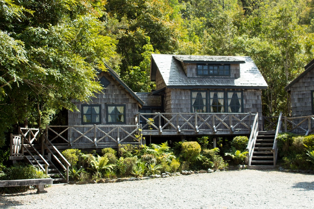 brown wooden house near green trees during daytime