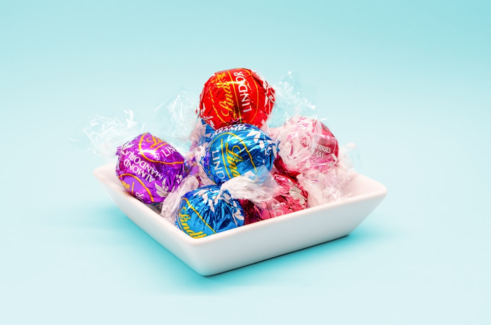 red and blue candy on white ceramic tray