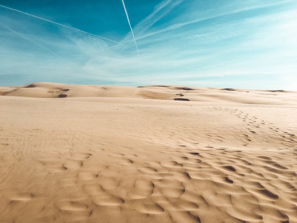 white sand under blue sky during daytime