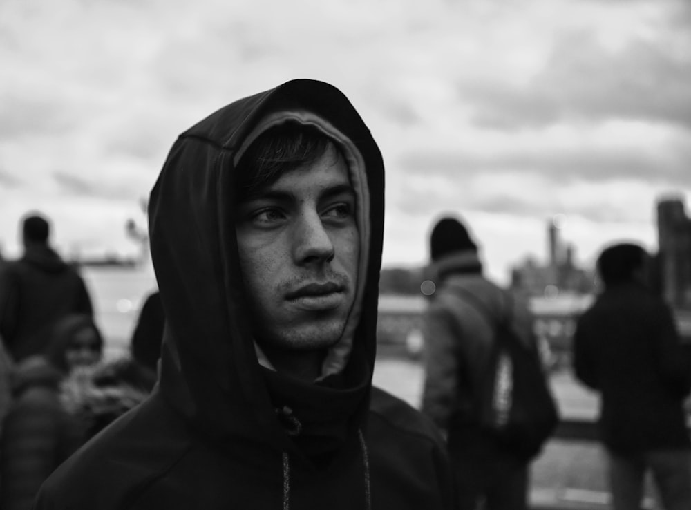 man in black hoodie in grayscale photography