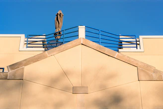 Modern beige awning over a villa terrace blending with earth tone surroundings.
