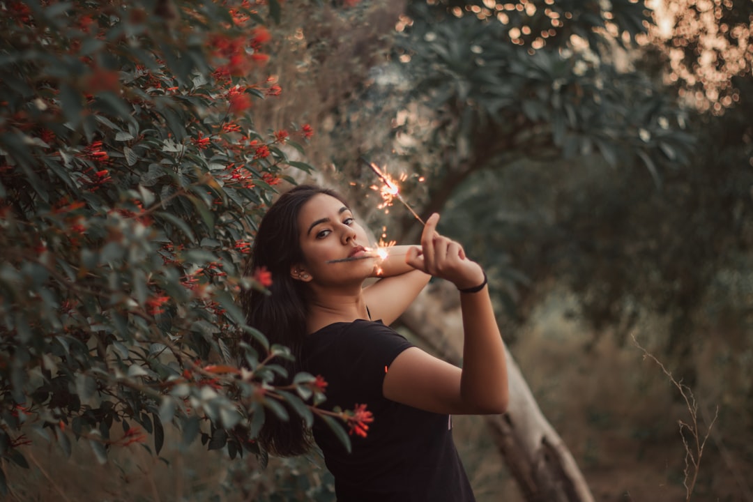 woman in black shirt standing near green plants during daytime