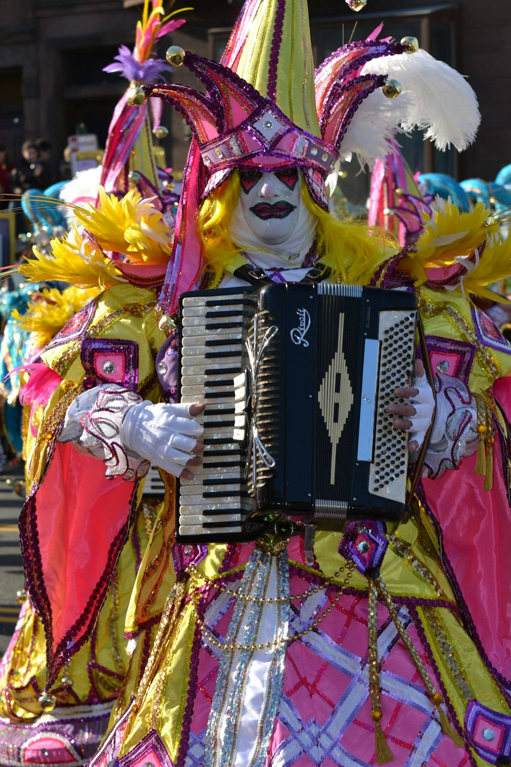 person in yellow and red costume playing black and white electric keyboard