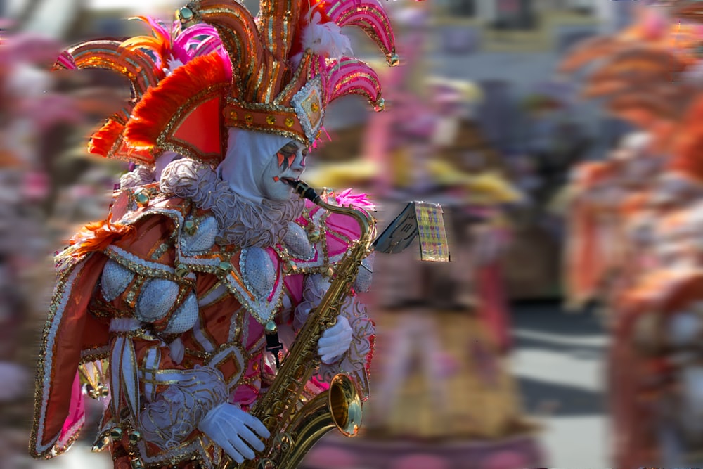 people in gold and red dragon costume walking on street during daytime