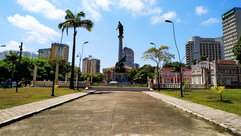 black statue near green trees during daytime