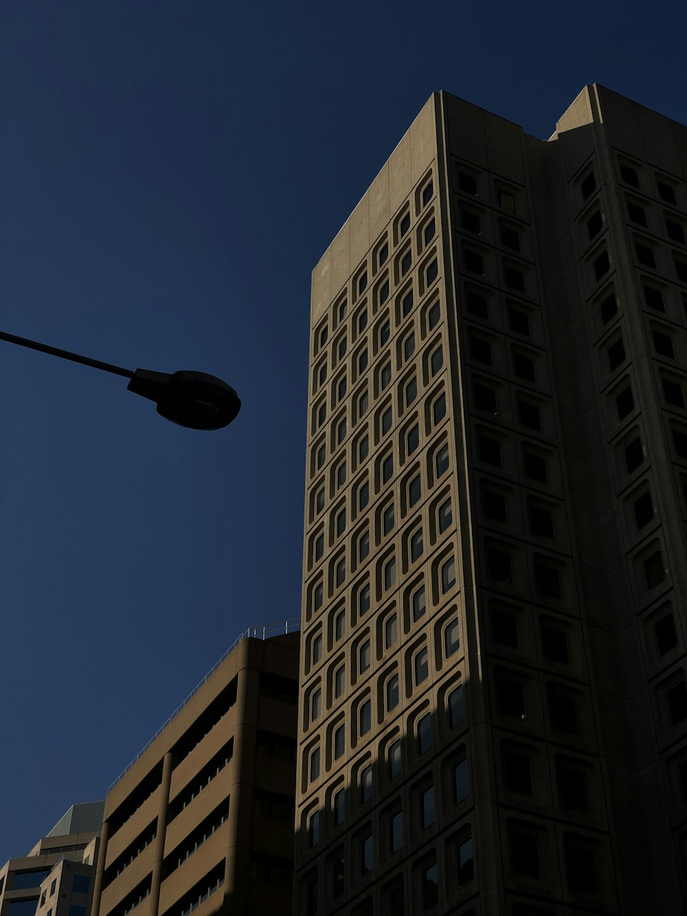 black street light near white concrete building during daytime