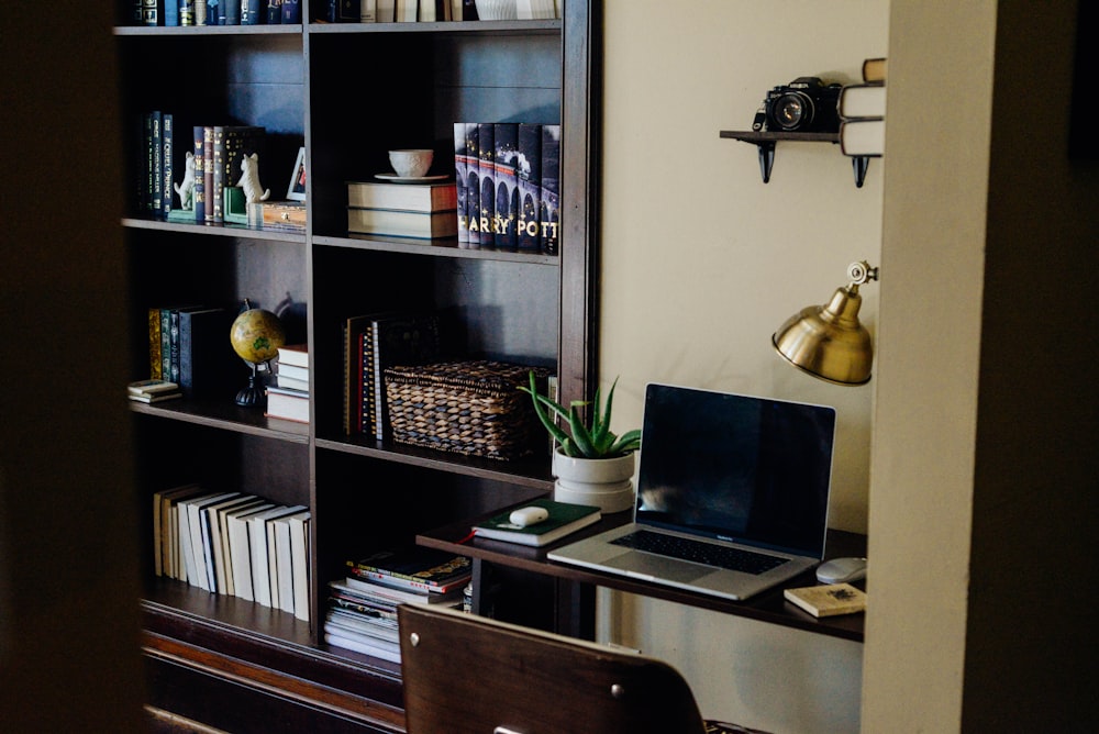 black laptop computer on brown wooden desk