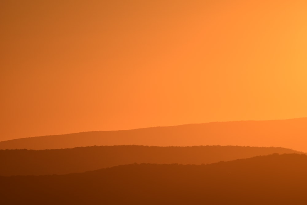 silhouette of mountain during sunset