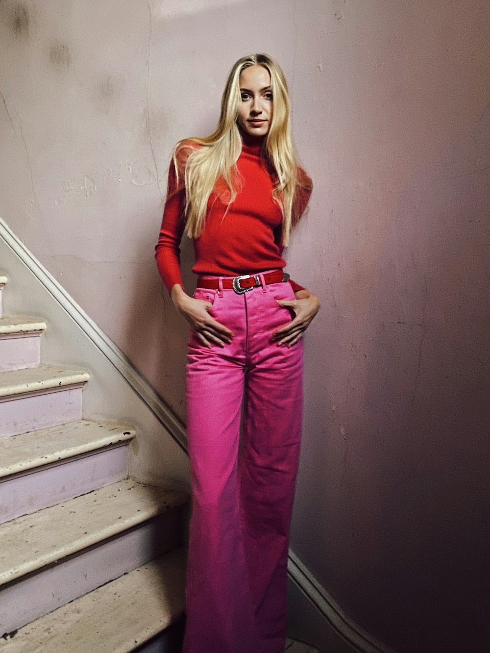 a woman in a red top and pink pants