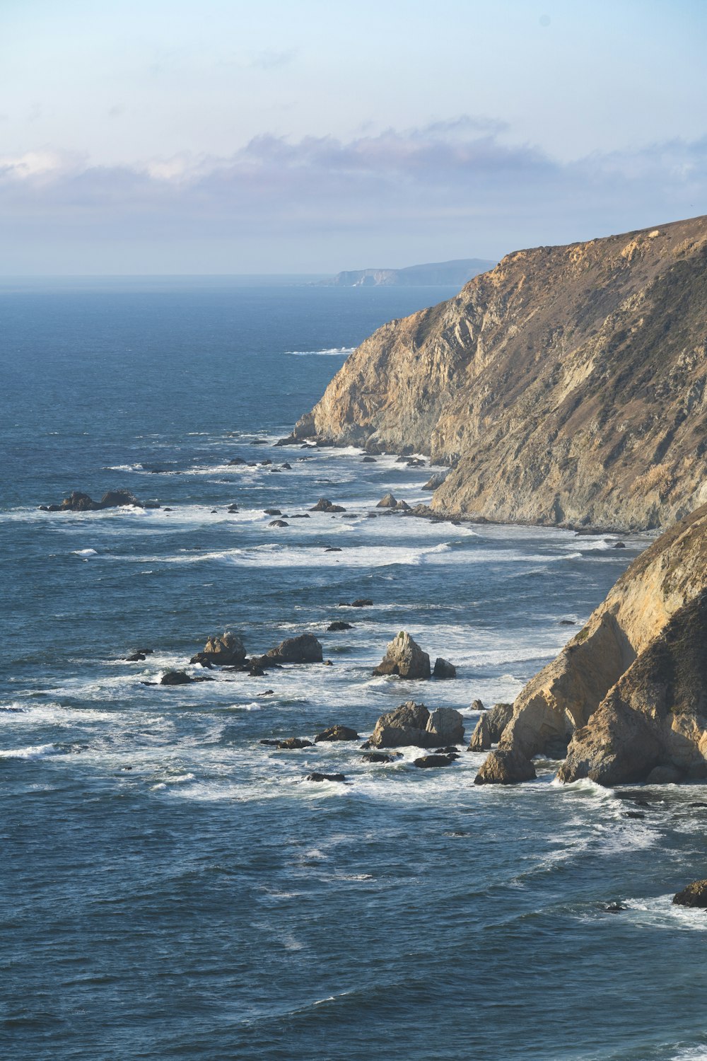 brown rock formation on sea during daytime