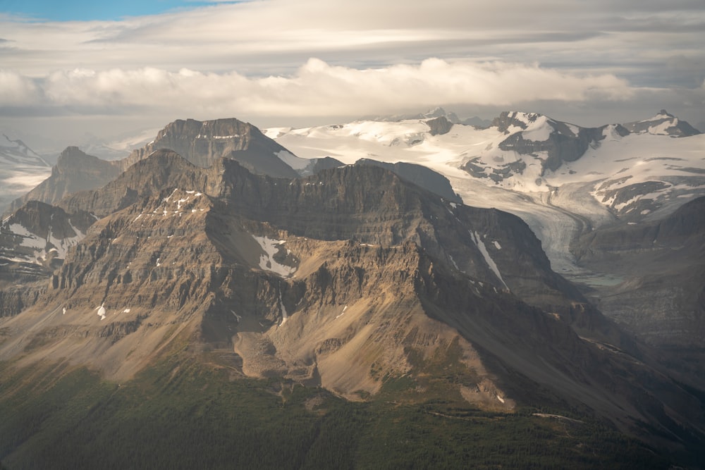 brown and gray mountains under white clouds during daytime