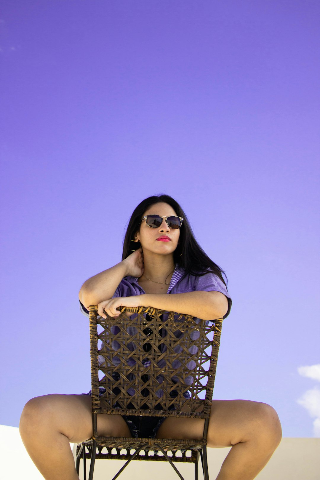 woman in black and white polka dot sleeveless dress wearing black sunglasses