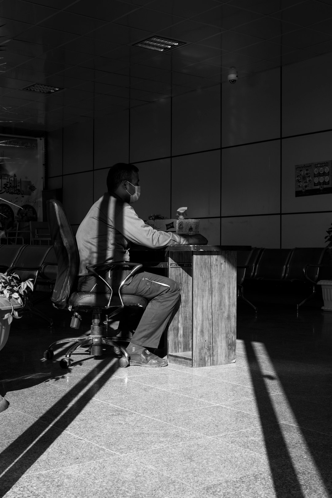 man in white dress shirt and black pants sitting on bench