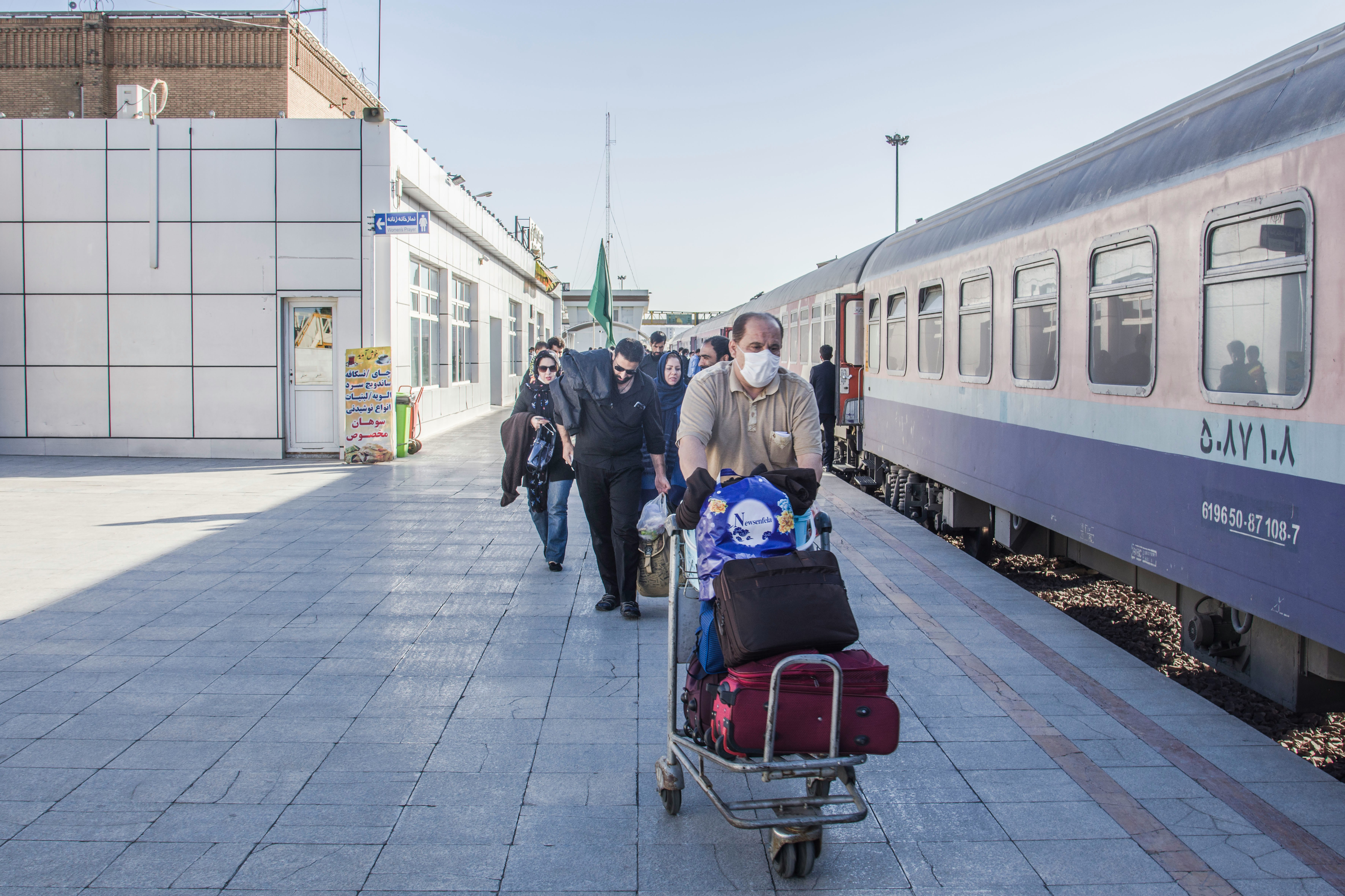 people standing near white train during daytime