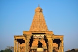 Ancient temple carvings at Marudamalai Hill Temple glowing in morning light.