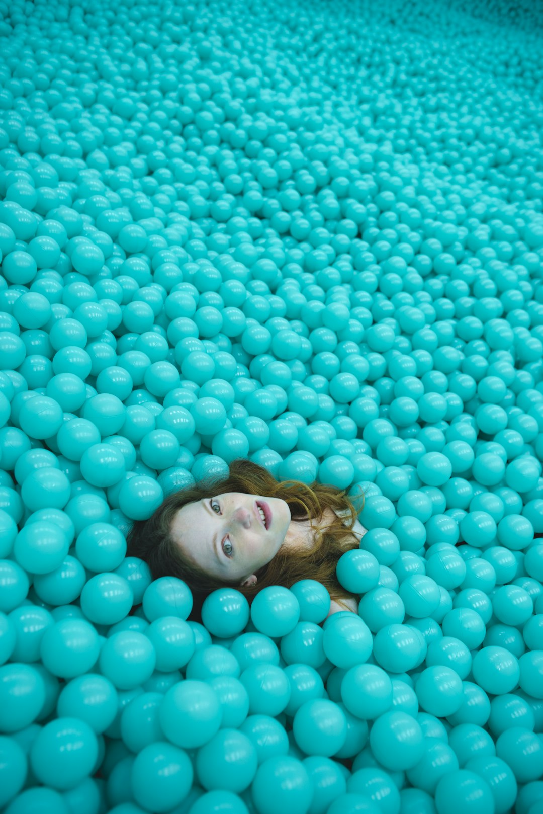 woman lying on blue round mat