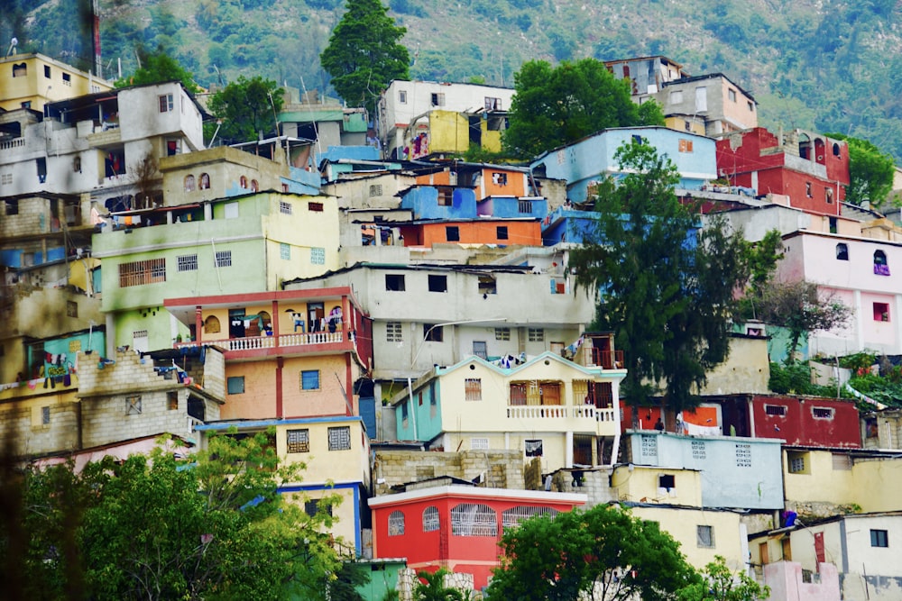 white and brown concrete houses near green trees during daytime