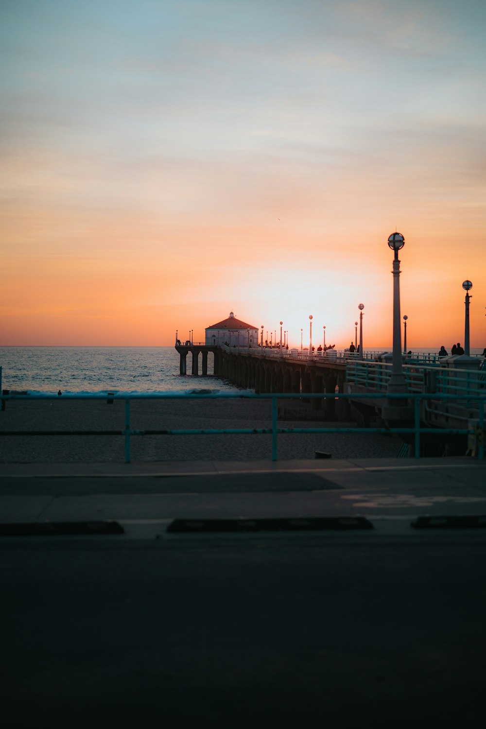 brown wooden dock on sea during sunset