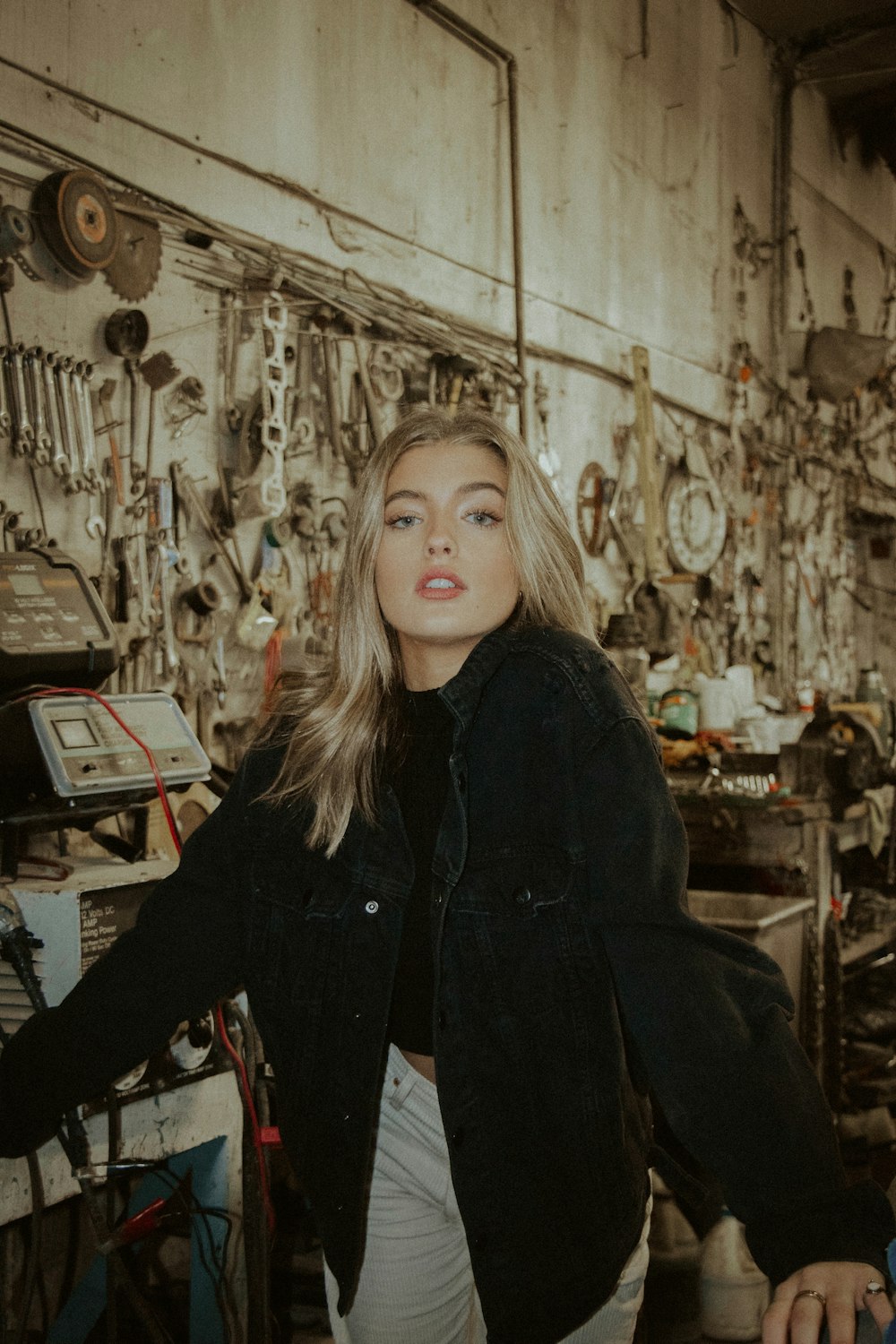 woman in black coat standing near brown wooden table