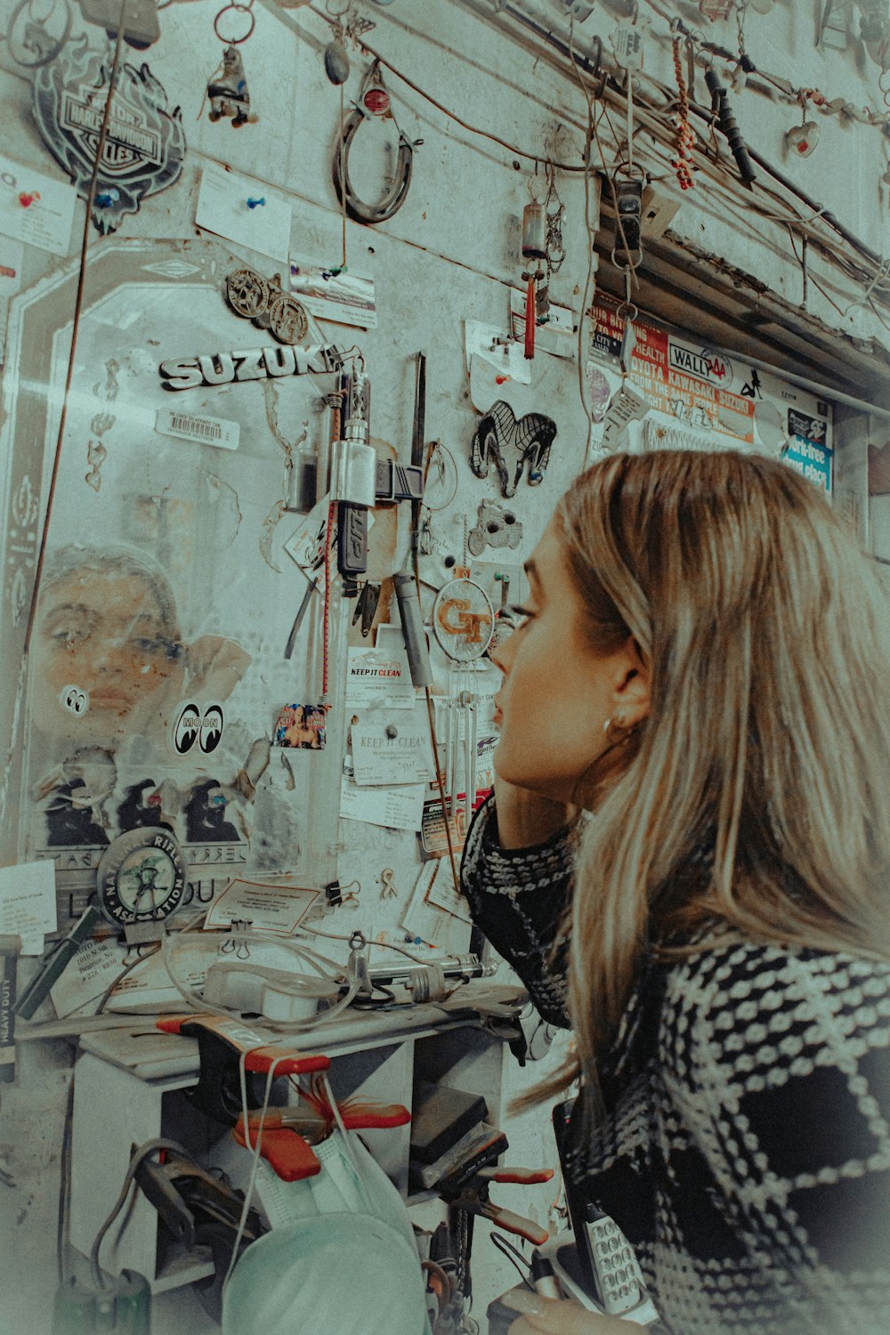 woman in black and white shirt standing near wall with graffiti