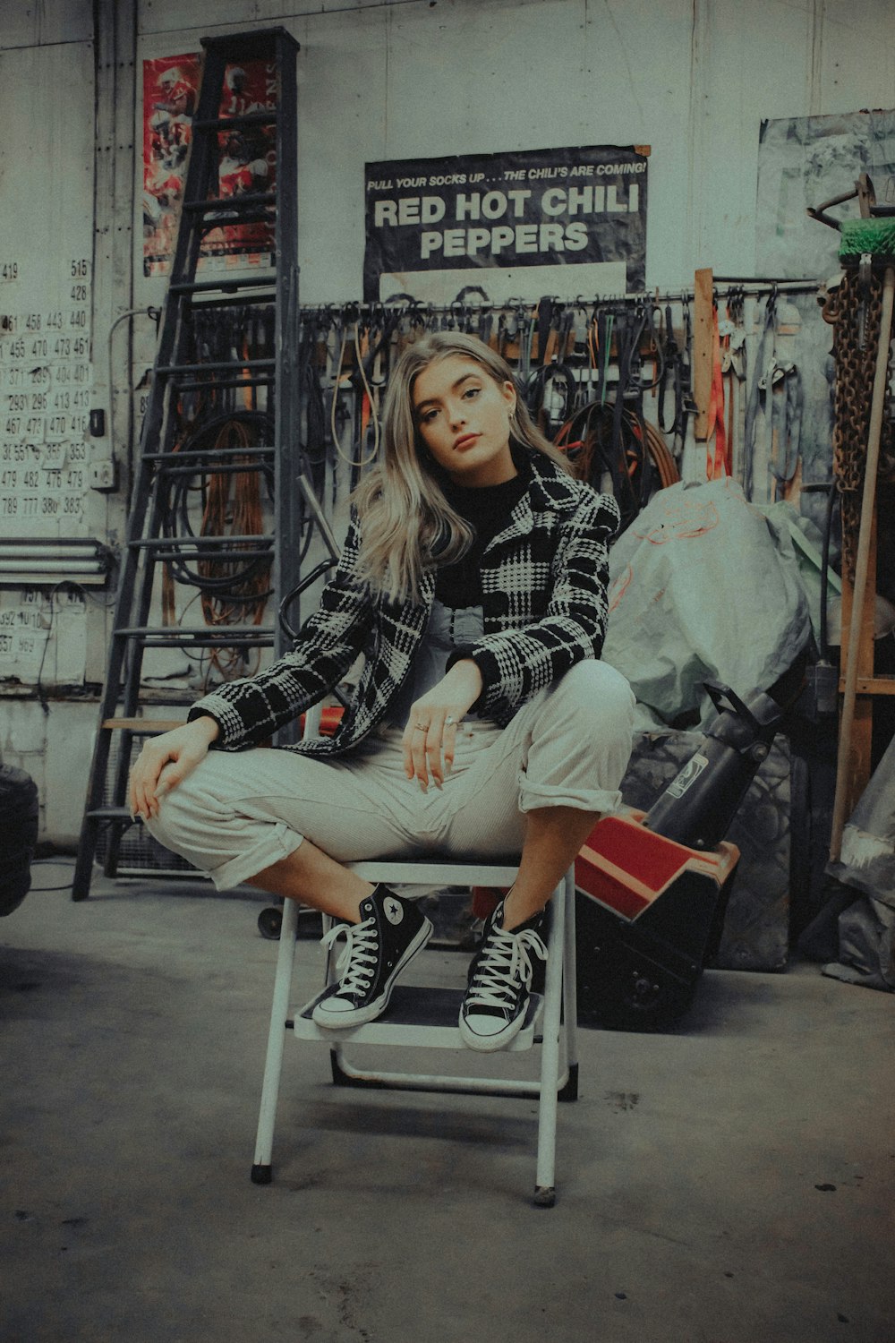 woman in black and white checkered long sleeve shirt sitting on white chair