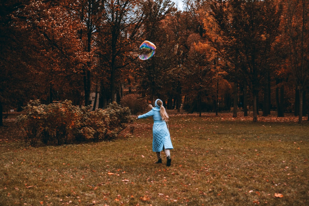 girl in white dress standing on brown grass field during daytime