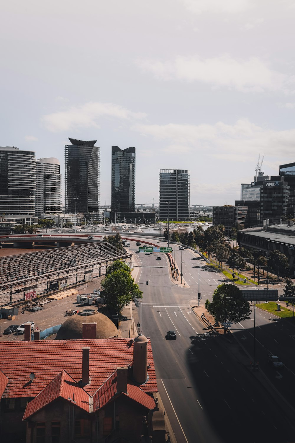 cars on road near city buildings during daytime