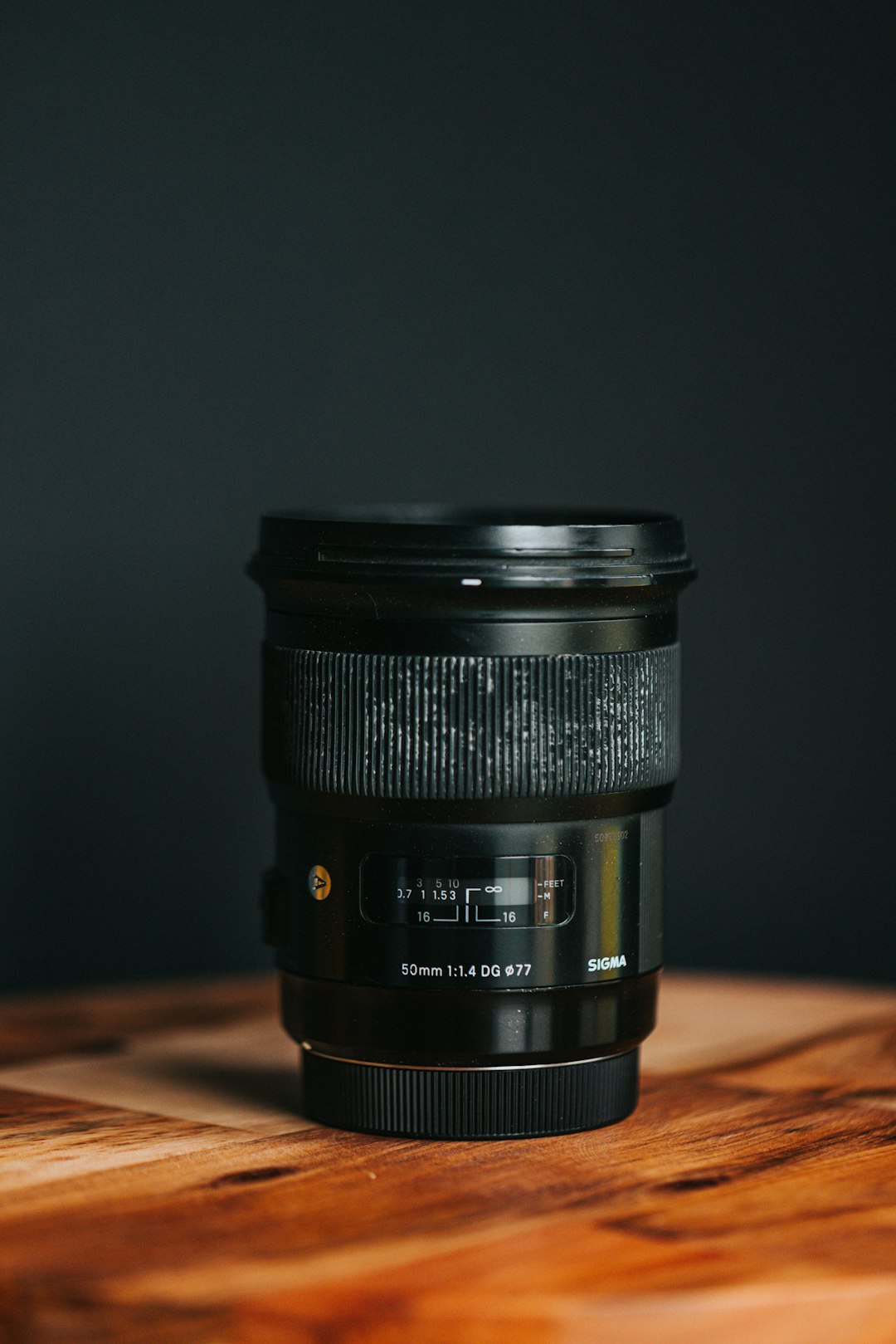 black camera lens on brown wooden table